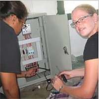 Intern wiring a DC Freezer system in a remote atoll in the Marshall Islands.